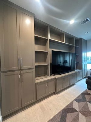 Angled three-quarter view of the painted built-in entertainment wall with flanking pantry towers